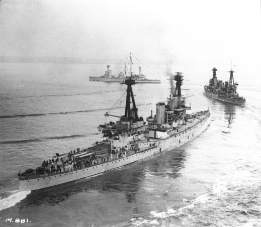 A black-and-white photograph showing three large warships.